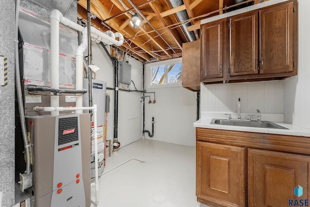 basement with heating unit, sink, gas water heater, and electric panel