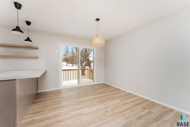 unfurnished dining area with light wood-type flooring