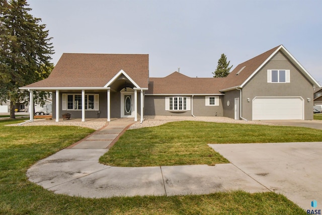 view of front of property with a porch, a garage, and a front yard