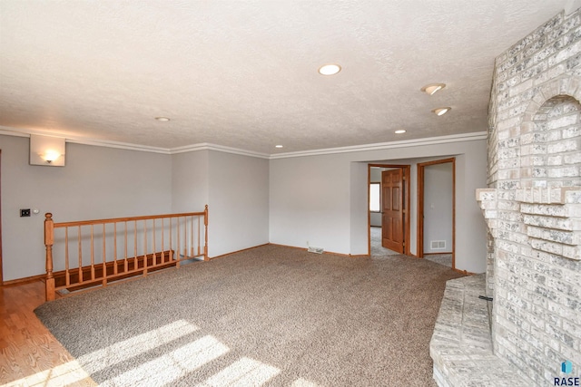 unfurnished room featuring crown molding and a textured ceiling