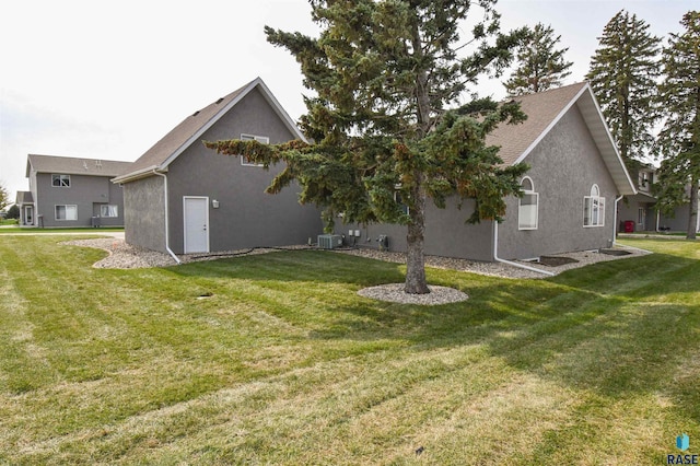 back of house with a yard and cooling unit