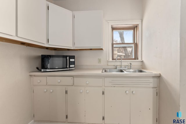 kitchen with white cabinetry and sink