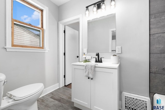 bathroom featuring vanity, hardwood / wood-style floors, and toilet