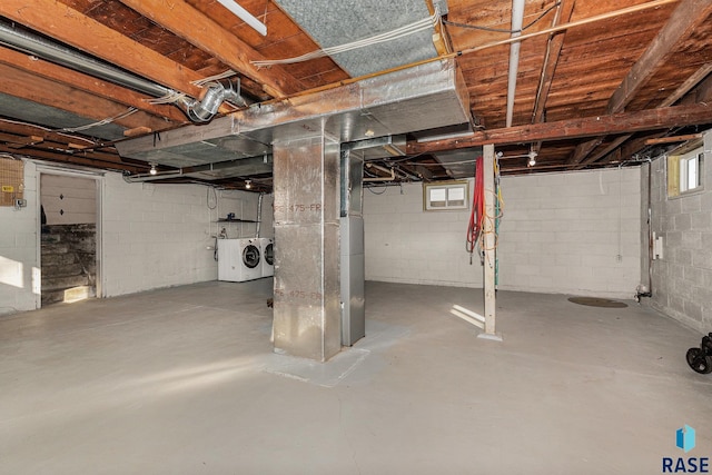 basement with separate washer and dryer and heating unit