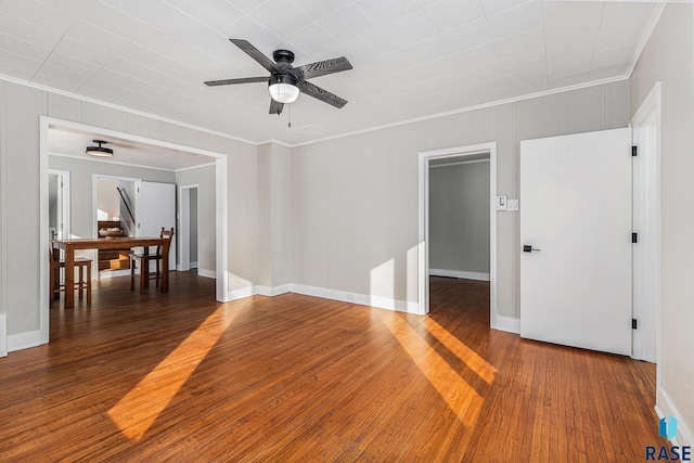 unfurnished room featuring crown molding, ceiling fan, and dark hardwood / wood-style flooring