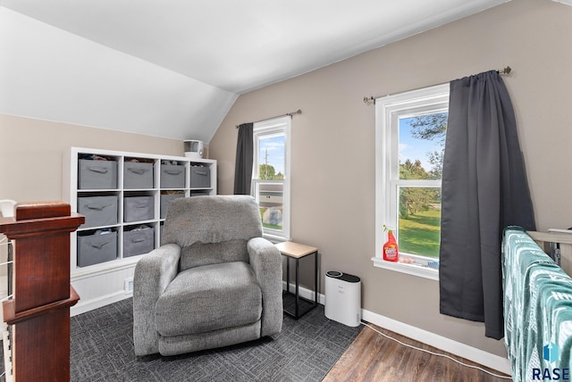 sitting room with dark hardwood / wood-style flooring and vaulted ceiling