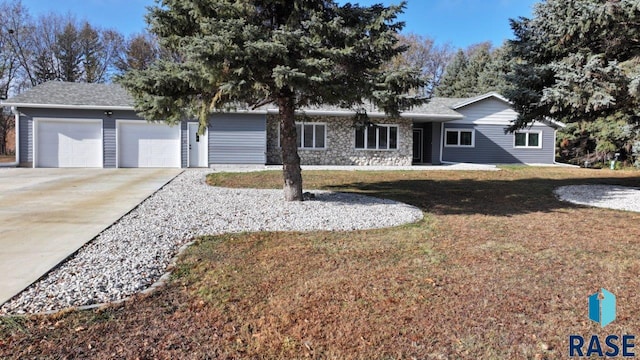 ranch-style home featuring a garage and a front yard