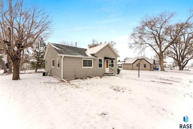 snow covered property featuring central AC