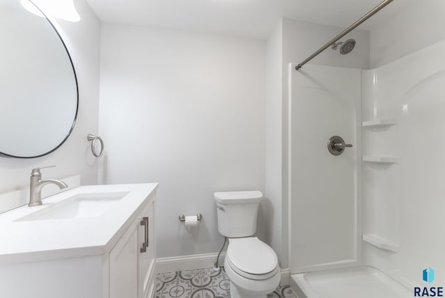 bathroom featuring a shower, vanity, and toilet