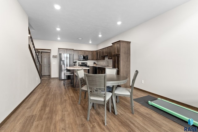 dining area with hardwood / wood-style floors and sink