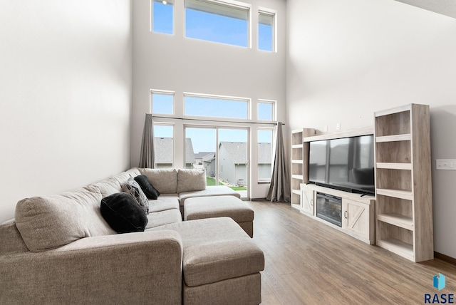 living room featuring hardwood / wood-style flooring and a high ceiling