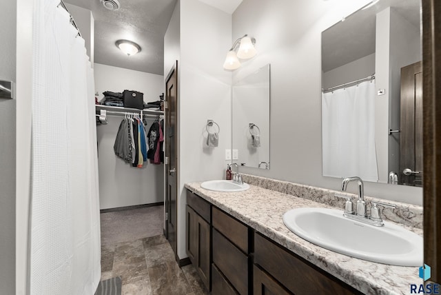 bathroom featuring vanity and a textured ceiling