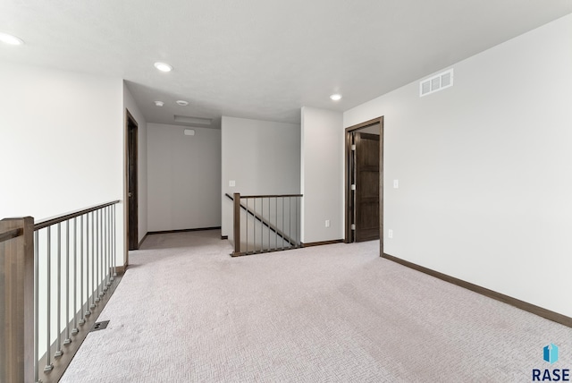 empty room with light colored carpet