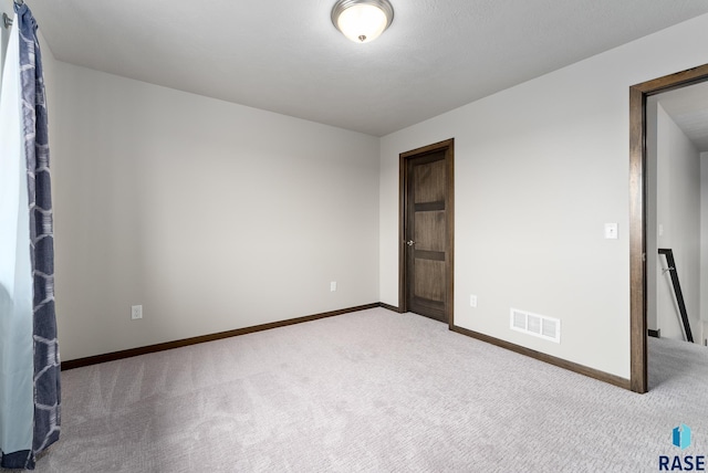 unfurnished bedroom featuring light carpet