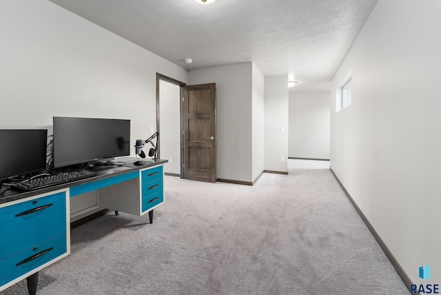 carpeted office space with a textured ceiling