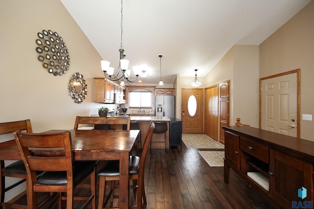 dining area with lofted ceiling, dark hardwood / wood-style floors, and a chandelier