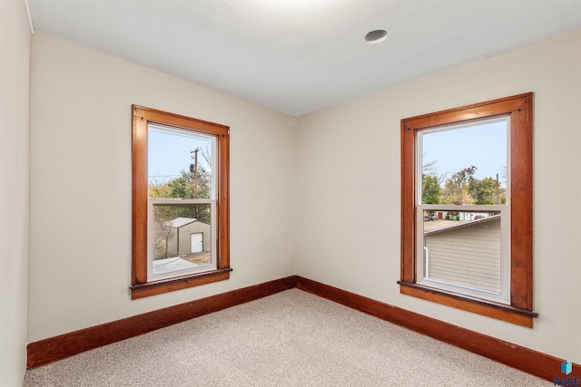 carpeted spare room featuring a wealth of natural light