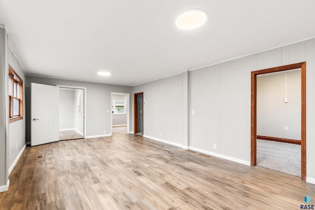 unfurnished bedroom featuring light hardwood / wood-style floors and a closet