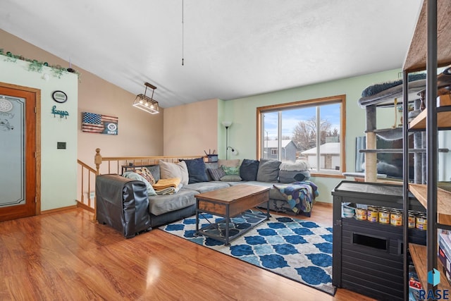 living room featuring hardwood / wood-style floors and vaulted ceiling