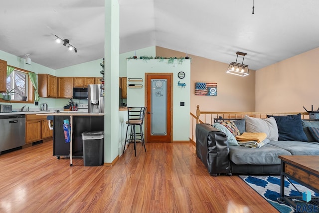 living room with vaulted ceiling and light hardwood / wood-style floors