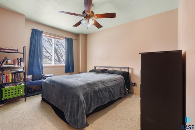 bedroom featuring light colored carpet and ceiling fan