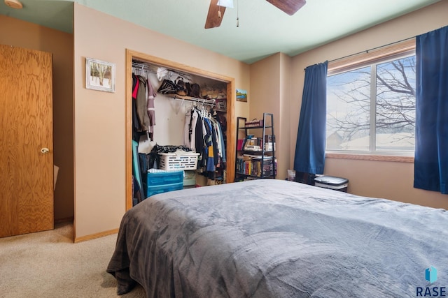 carpeted bedroom featuring a closet and ceiling fan