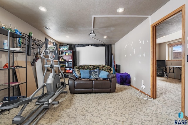 workout room featuring carpet floors and a textured ceiling