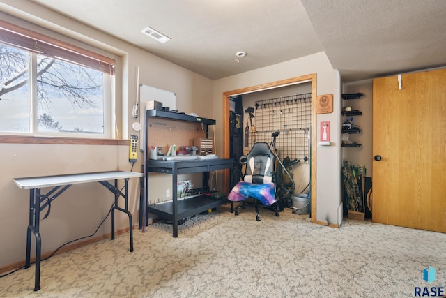 carpeted bedroom featuring a textured ceiling