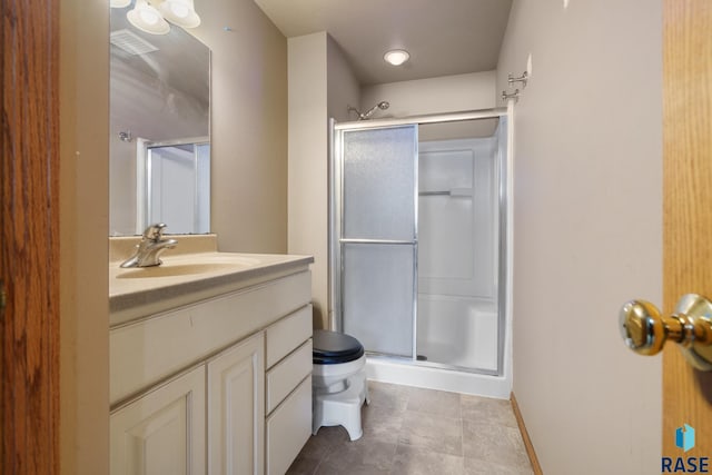 bathroom with walk in shower, vanity, and toilet