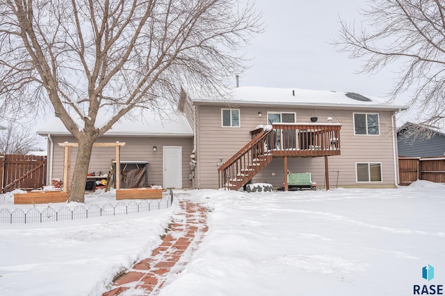 snow covered property featuring a wooden deck