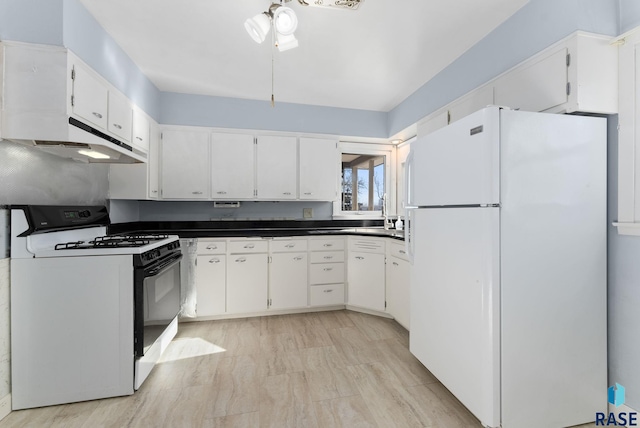 kitchen featuring white cabinets, white fridge, range with gas stovetop, and ceiling fan