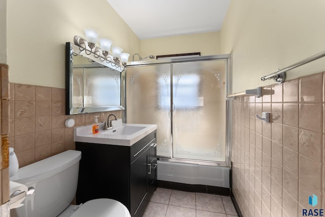 full bathroom featuring tile walls, vanity, tile patterned flooring, and shower / bath combination with glass door