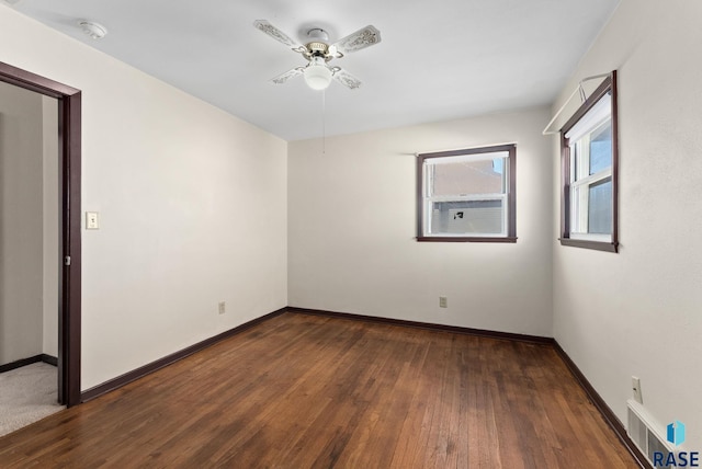 spare room with ceiling fan and dark hardwood / wood-style flooring