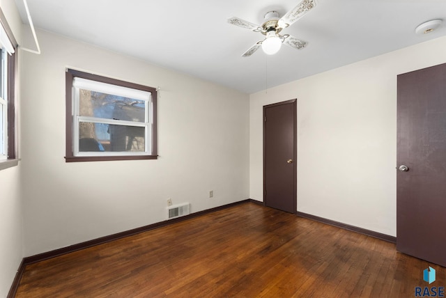 unfurnished room with ceiling fan and dark hardwood / wood-style flooring