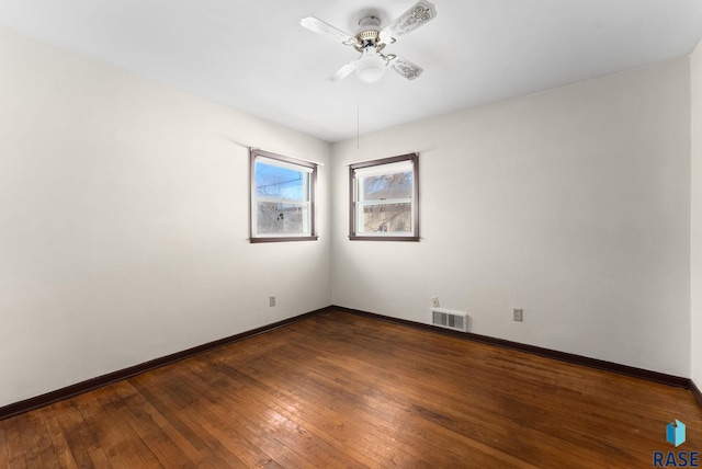 spare room featuring wood-type flooring and ceiling fan