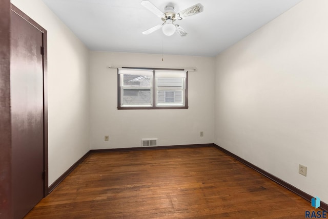 empty room featuring dark hardwood / wood-style floors and ceiling fan