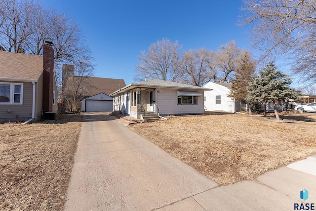 view of front of property with an outbuilding, cooling unit, and a garage