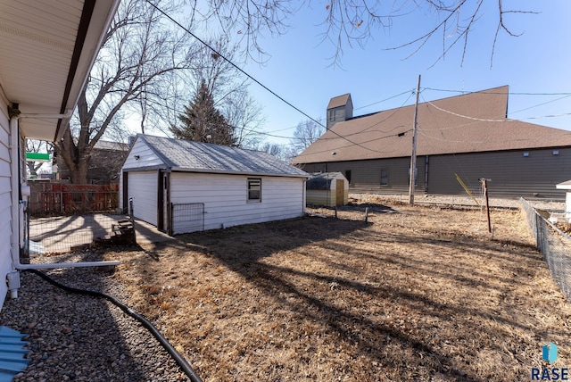 exterior space featuring a garage and an outbuilding