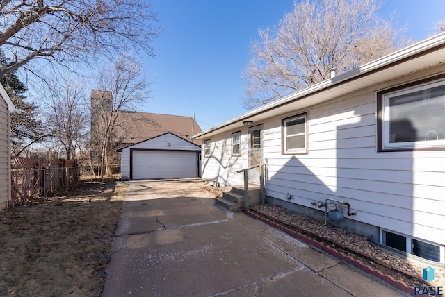 exterior space with a garage and an outdoor structure