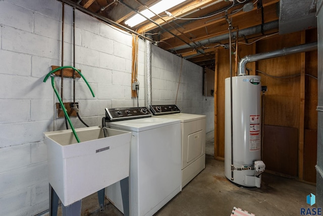 laundry area with gas water heater, sink, and washer and clothes dryer