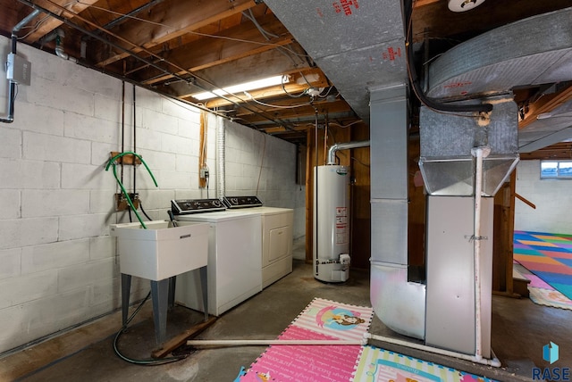 basement featuring water heater, heating unit, and independent washer and dryer