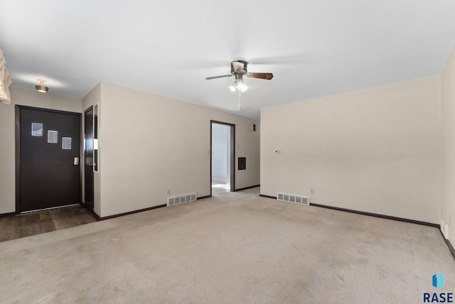 empty room with ceiling fan and light colored carpet