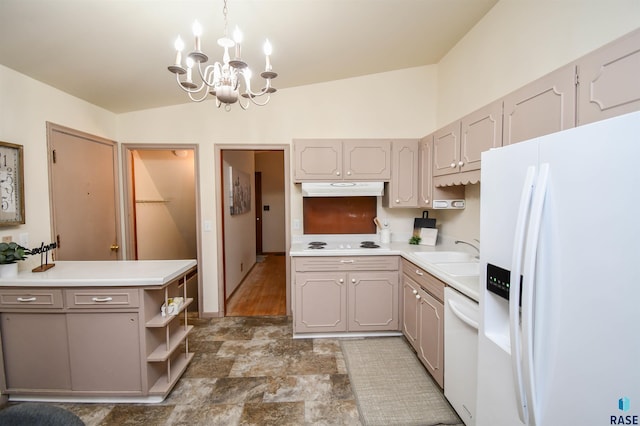 kitchen with sink, white appliances, an inviting chandelier, hanging light fixtures, and kitchen peninsula