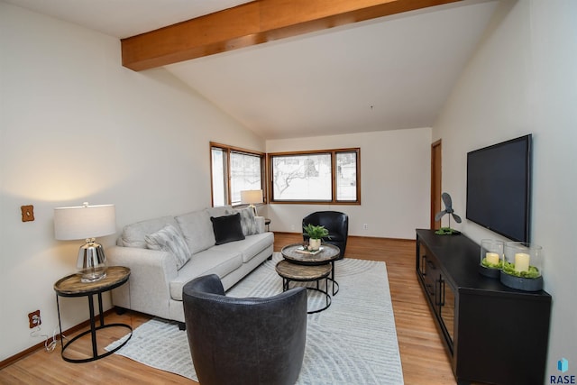 living room with vaulted ceiling with beams and light hardwood / wood-style floors