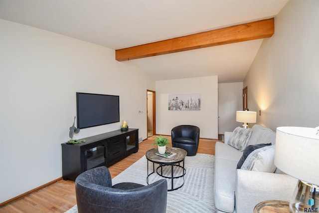 living room with vaulted ceiling with beams and light wood-type flooring