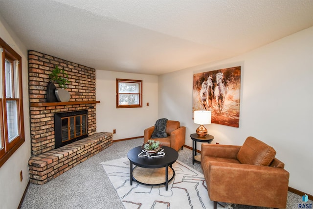 living room with carpet, a textured ceiling, and a brick fireplace