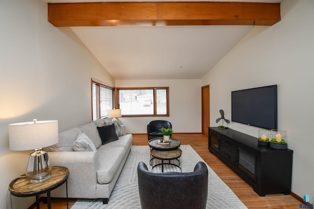 living room with lofted ceiling with beams and light hardwood / wood-style floors