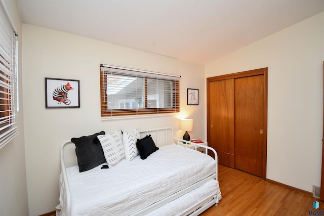 bedroom featuring a closet and light hardwood / wood-style flooring