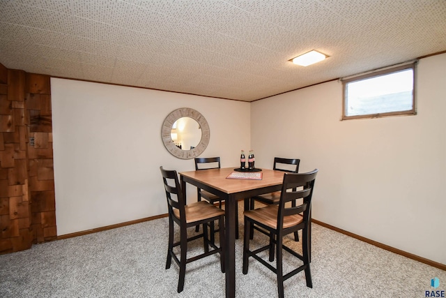 carpeted dining area with a textured ceiling