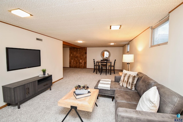 living room with ornamental molding and carpet floors